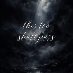 Dark moody mountain landscape with mist, dramatic clouds, and a beam of light with the text ‘this too shall pass’